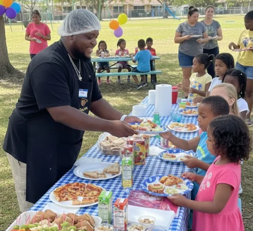 M&J team serving food to students